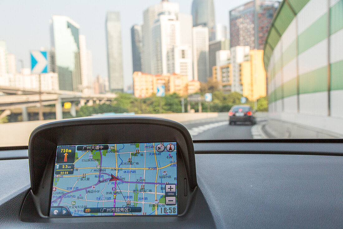 Taxi ride, GPS screen, Navigational Positioning System in Chinese Taxi, driving, cab drive, road, high-rise, view through car window, Guangzhou, Canton, Guangdong Province, China, Asia