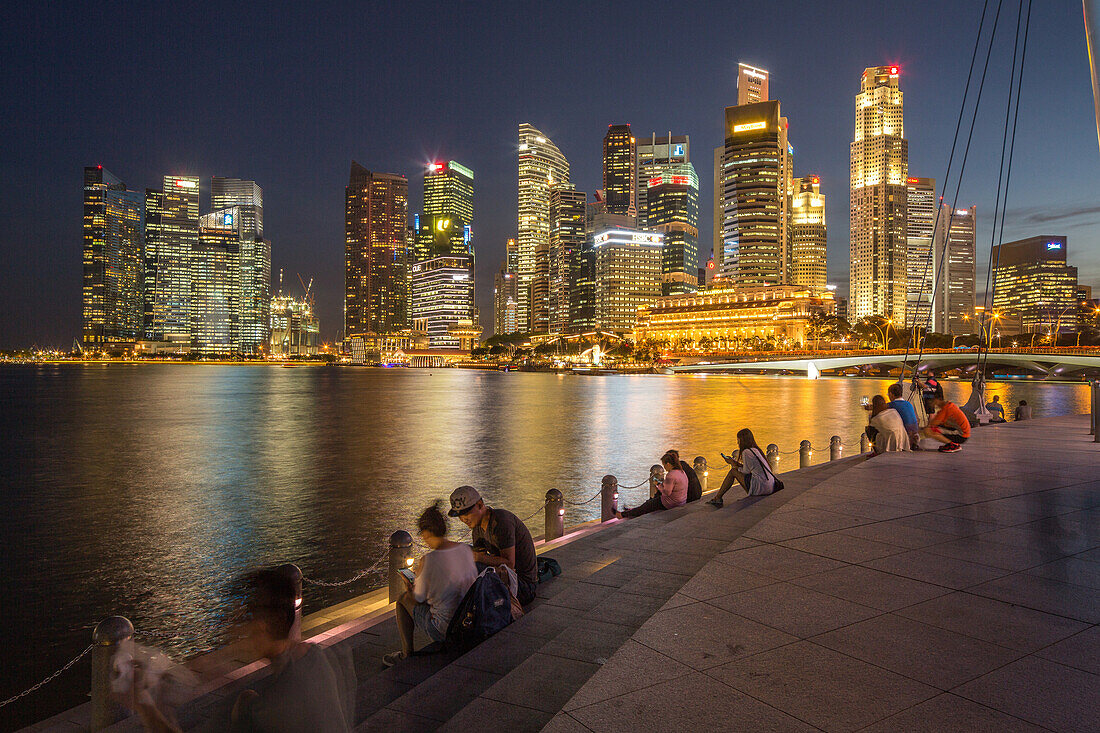 evening, Marina Bay, waterfront, people sitting on stone steps, Singapore Skyline and historic Fullarton Hotel, city, business, high-rise, Singapore, Asia