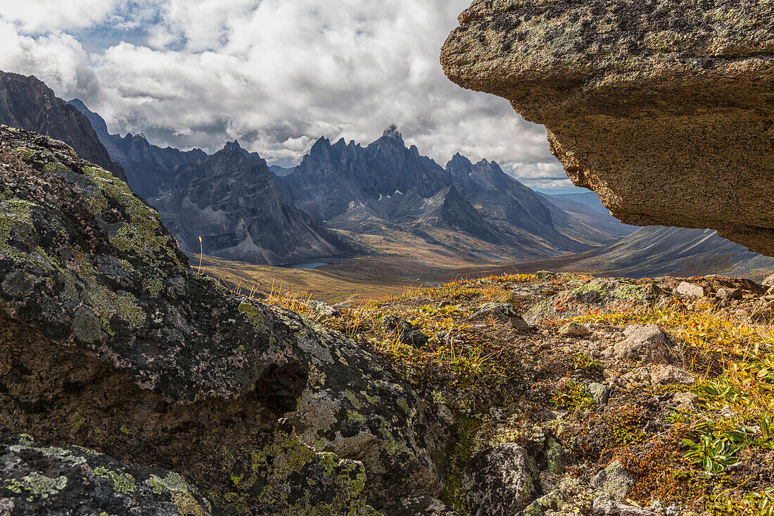 Tombstone Mountain is framed by rocks in this view within Tombstone Territorial Park, Yukon, Canada