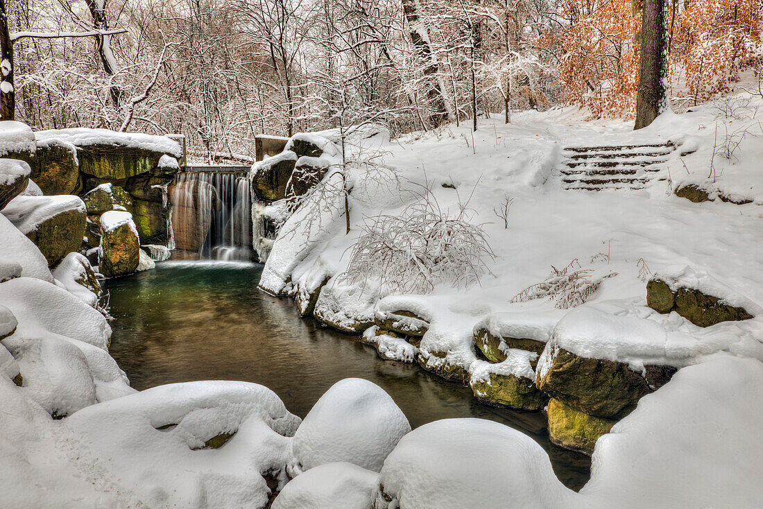 Snow-covered waterfall in The Loch, Central Park, New York City, New York, United States of America