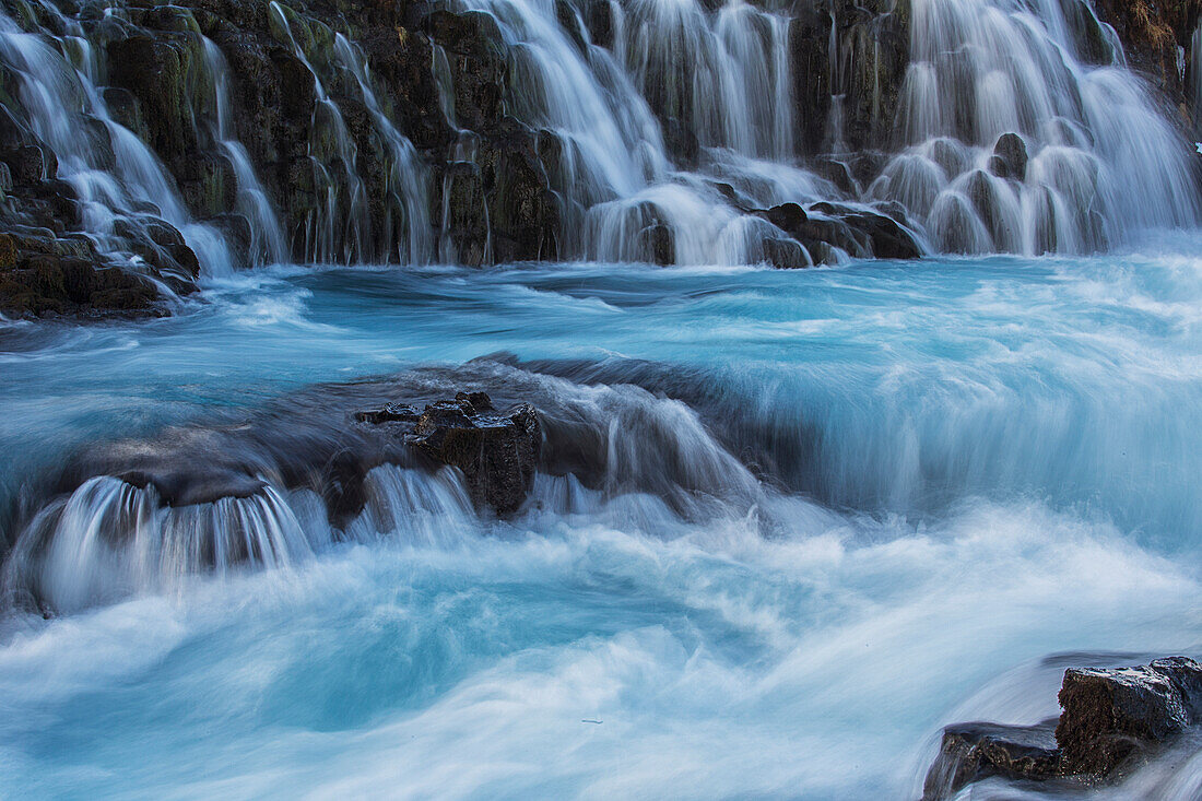 Water cascading over rocks into a turquoise river, Bruarfoss, Iceland