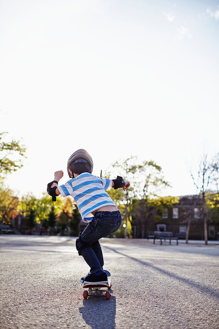 Young boy riding a skateboard, Montreal, Quebec, Canada