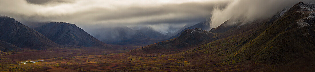 The Blackstone Valley along the Dempster Highway is shrouded in clouds in autumn, Yukon, Canada