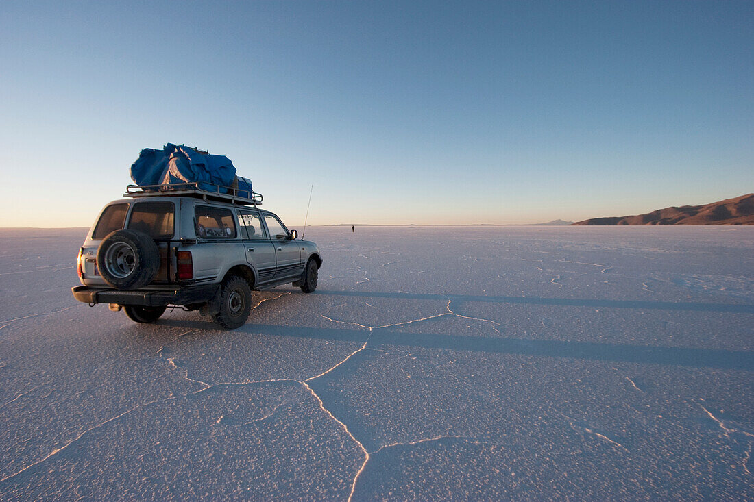 4X4 Vehicle In The Salar De Uyuni, The World's Largest Salt Flat At Sunrise, Potosi Department, Bolivia