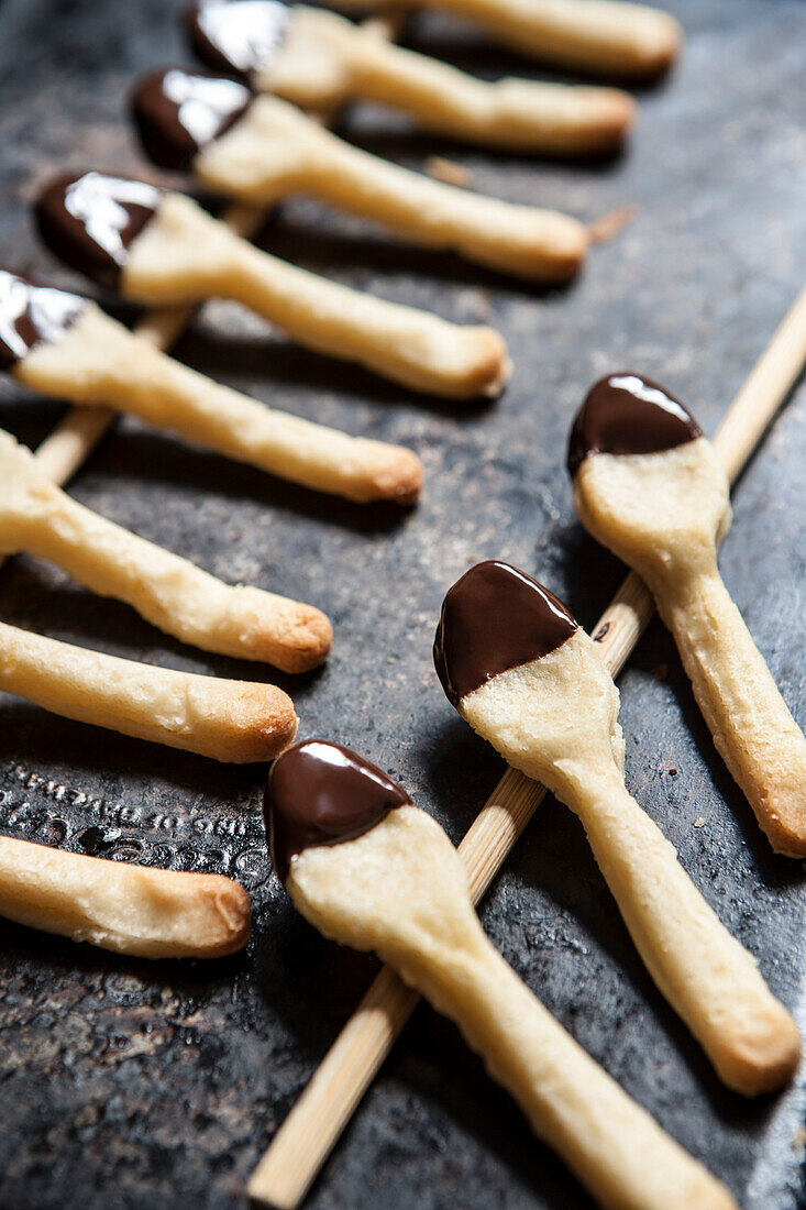 Two Rows of Cookie Spoons Dipped in Chocolate, Close-Up