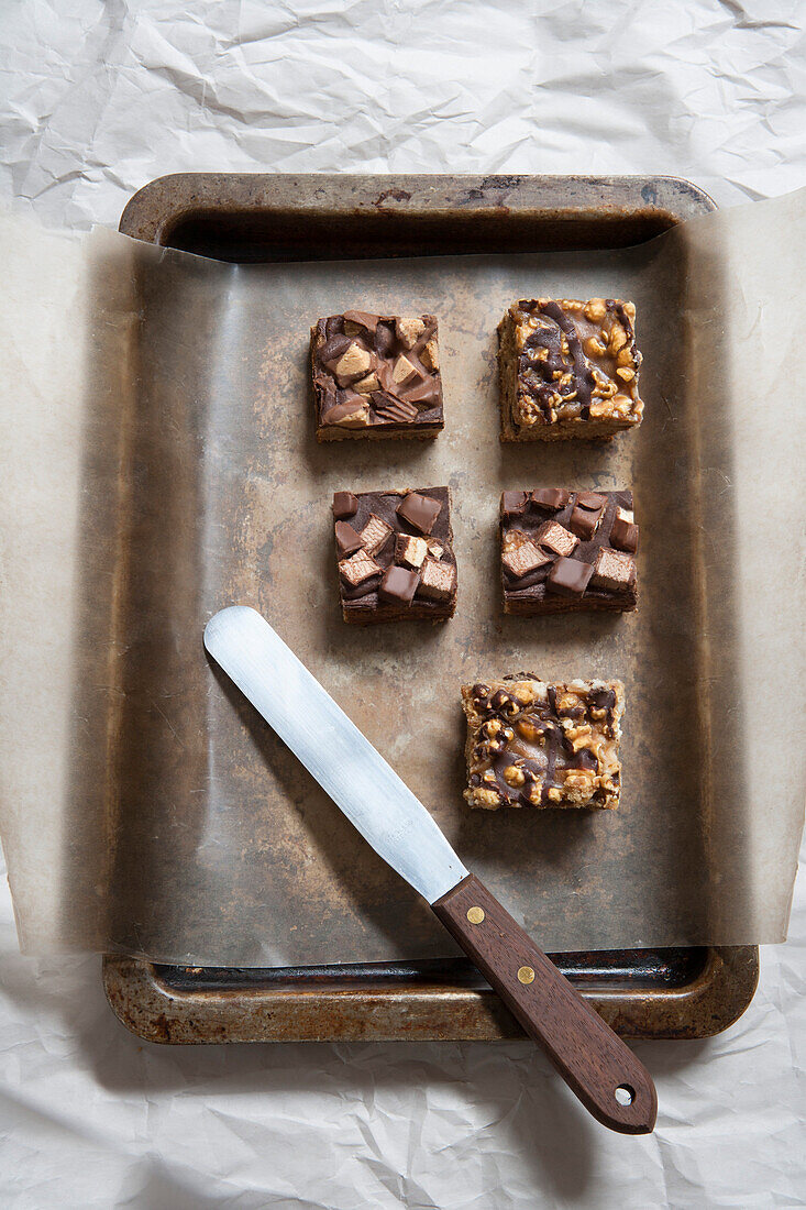 Short Bread Squares with Chocolate Candy Topping and Chocolate Chip Squares with Caramel Popcorn Topping