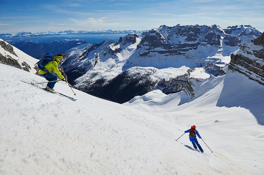 Two men skiing from the peak of Bocchetta die Tres Cime in the Area of the Brenta Dolomites Madonna di Campiglio, Skitour, Brenta Gebirge, Dolomites, Trentino, Italien