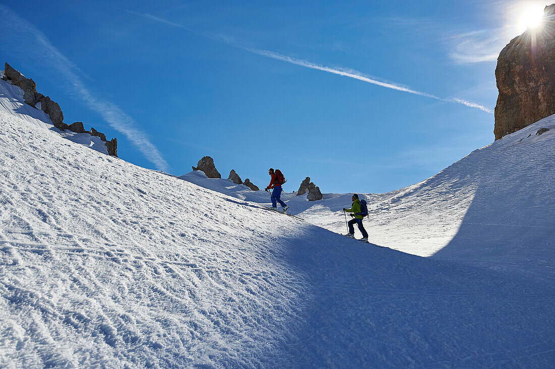 Two Men are skitouring right beneath the peak of Bocchetta die Tres Cime in the Area of the Brenta Dolomites Madonna di Campiglio, Skitour, Brenta Gebirge, Dolomites, Trentino, Italien