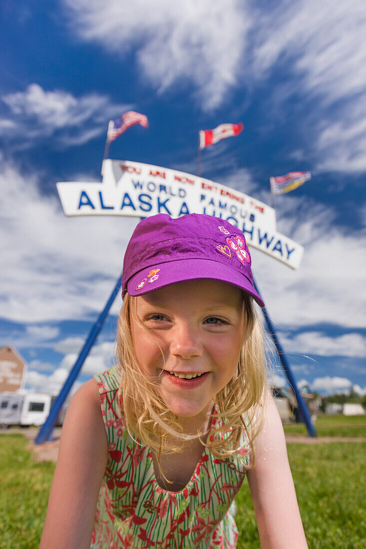 A Young Girl under the World Famous Alaska Highway Sign, Dawson Creek, British Columbia, Canada, Summer