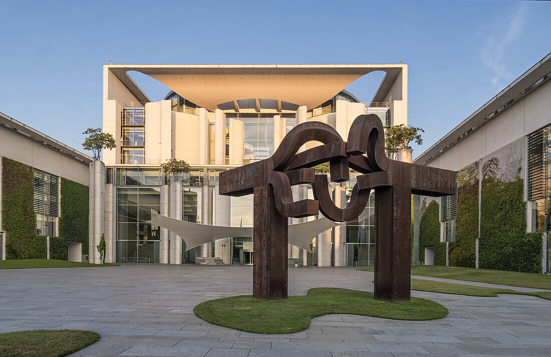 Sunrise at German federal chancellery, Bundeskanzleramt with steel sculpture ''Berlin'' by Basque artist Eduardo Chillida, Berlin, Germany