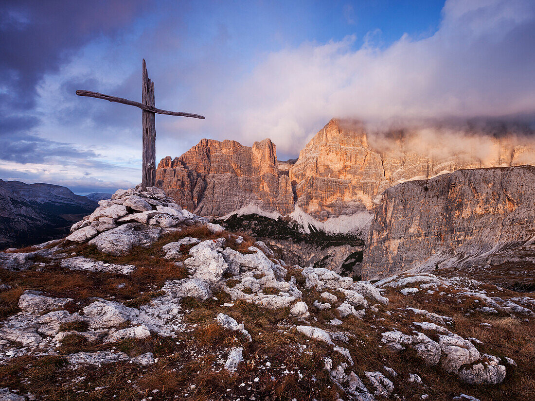 Soldiers grave in the Dolomites above the Passo Valparola with dramatic lighting above the Zimes de Fanes, Belluno, Italy