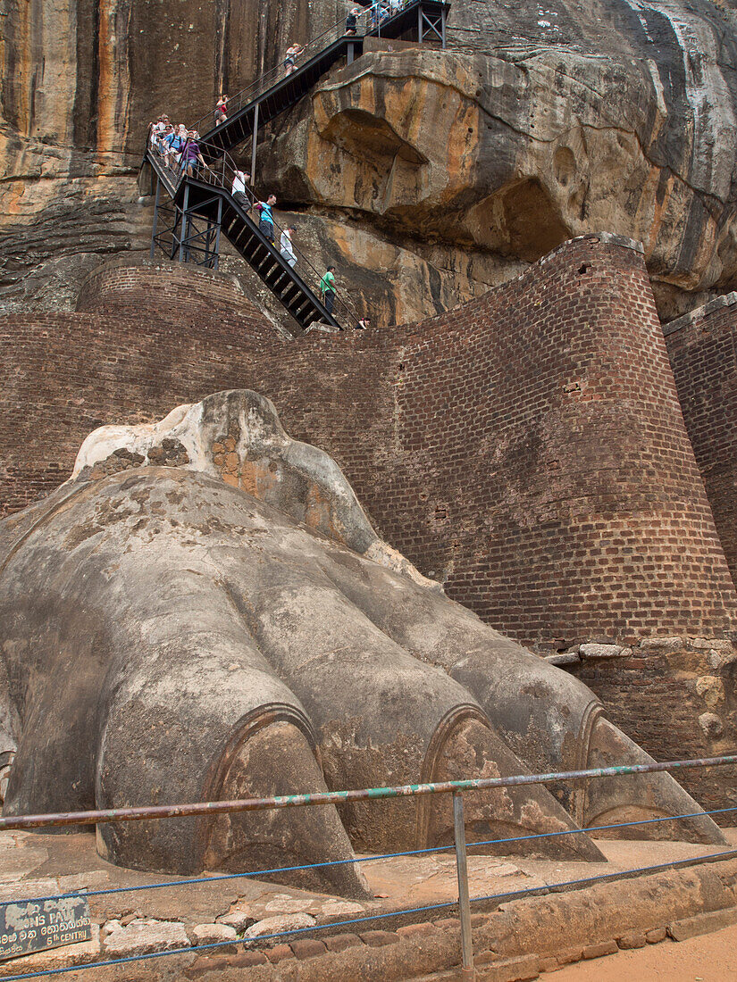 Tourists visit the ancient city of Sigiriya, with carvings on a rock in a mountain fortress, UNESCO World Heritage Site, Sri Lanka, Asia