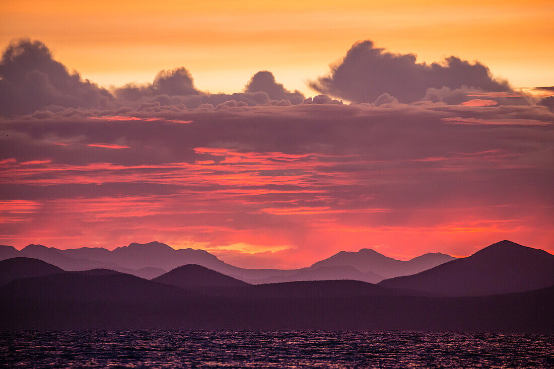 Intense clouds and sunset over Baja Peninsula from Isla Ildefonso, Baja California Sur, Mexico, North America