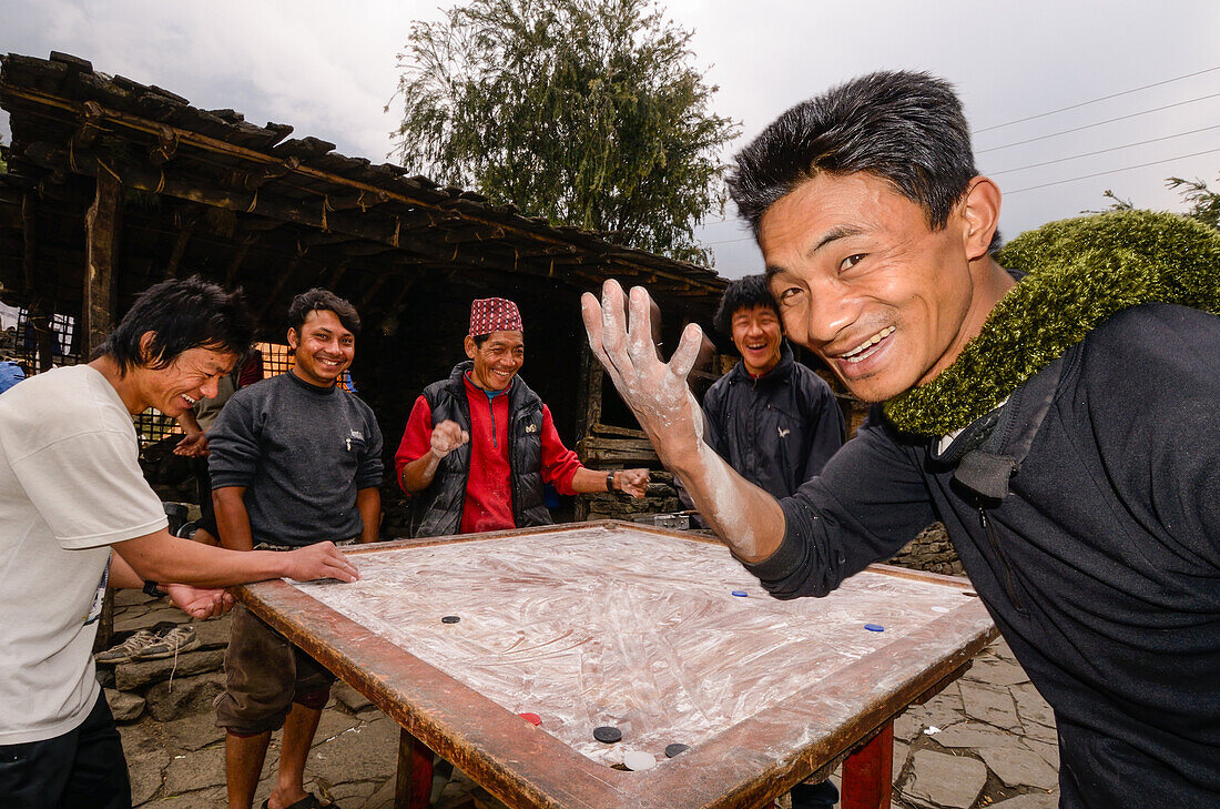 Young men playing Carrom, the Nepalese national sport, Nepal, Himalaya, Asia