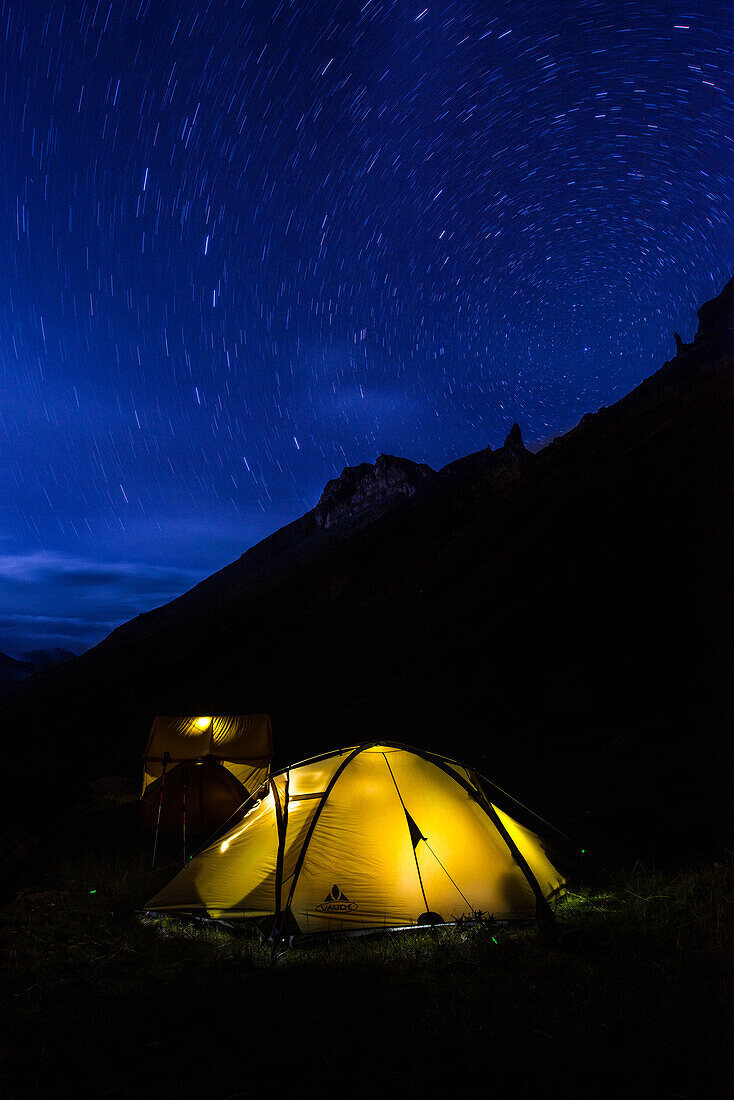 Bright luminescent tent beneath the star carousel in the High Camp on the way from Nar over Teri La to Mustang, Nepal, Himalaya, Asia