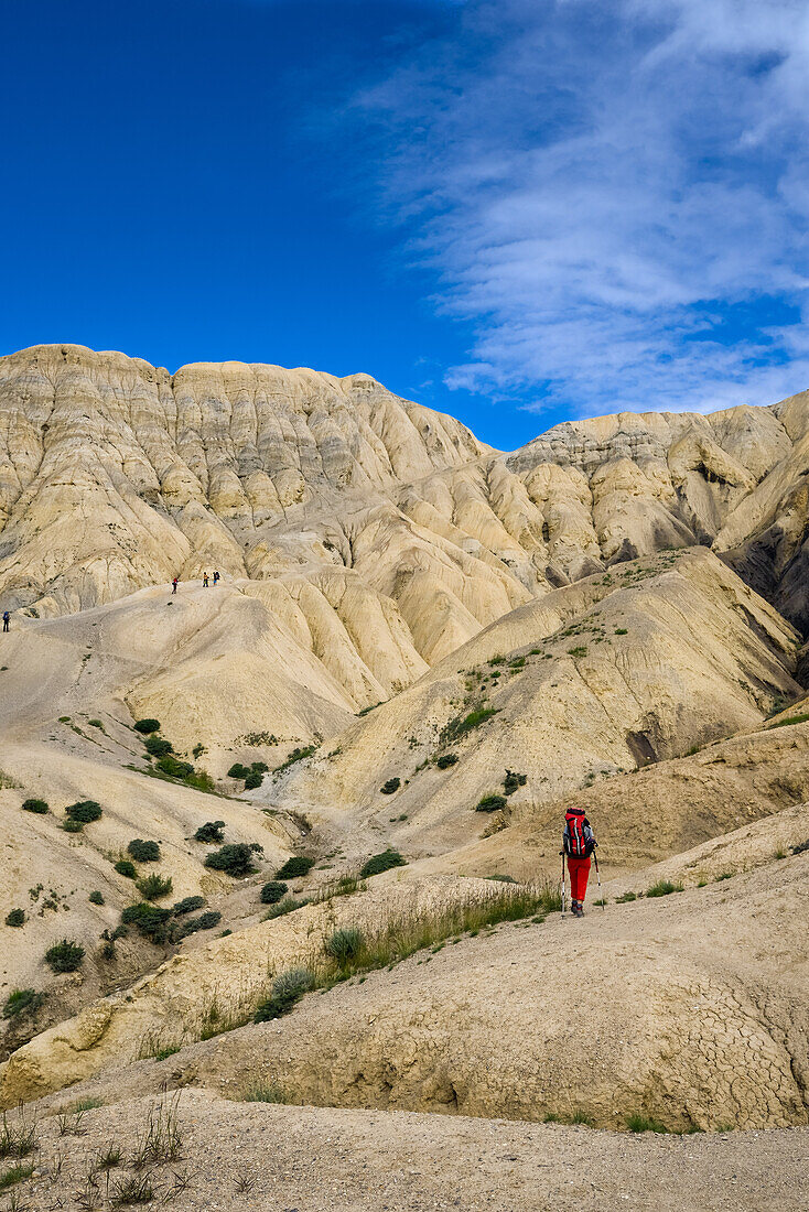 Young woman, hiker, trekker in the surreal landscape typical for Mustang in the high desert around the Kali Gandaki valley, the deepest valley in the world, Mustang, Nepal, Himalaya, Asia