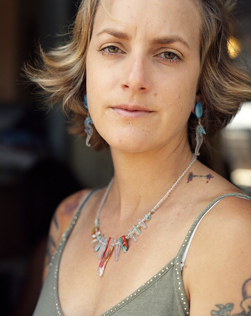 Close up of serious woman wearing jewelry