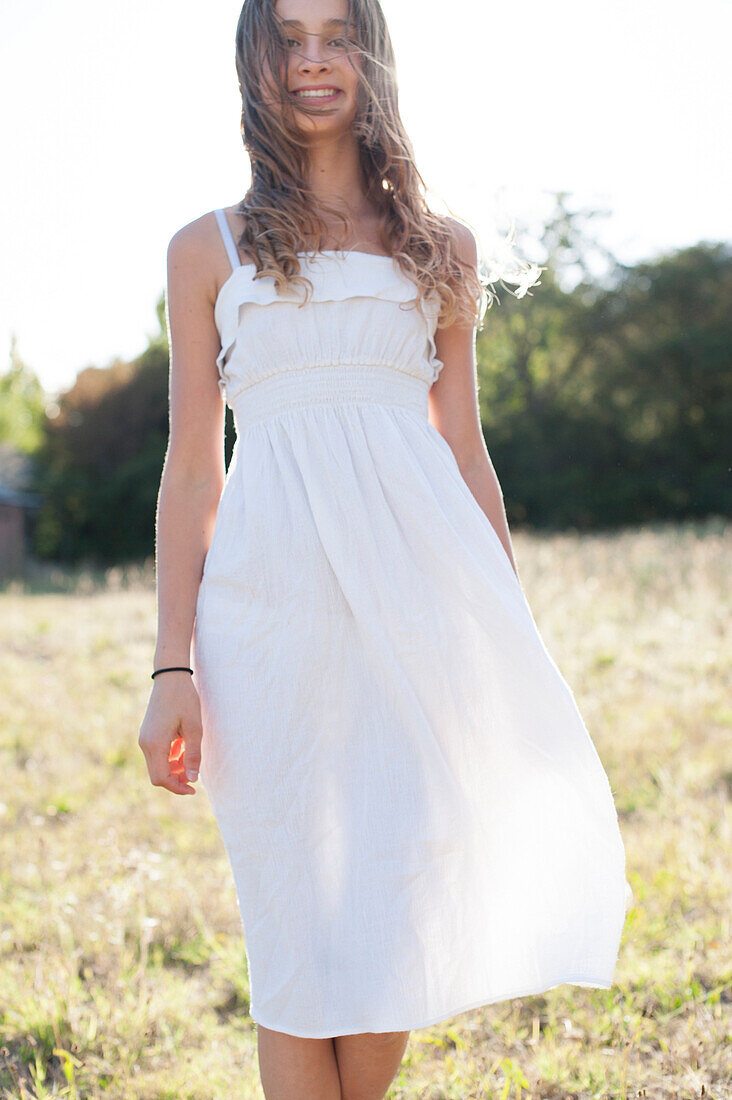 Smiling girl walking in field