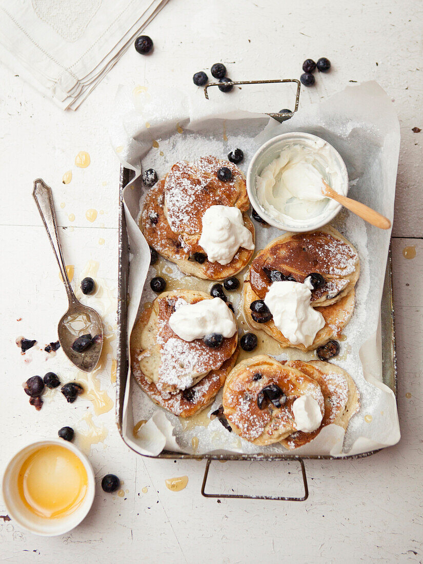 Tray of pancakes with fruit and cream