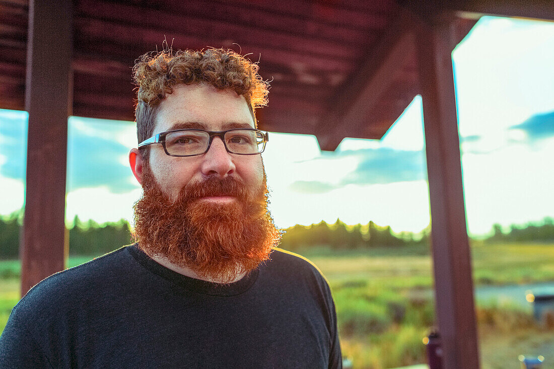 Caucasian man standing on patio in remote field