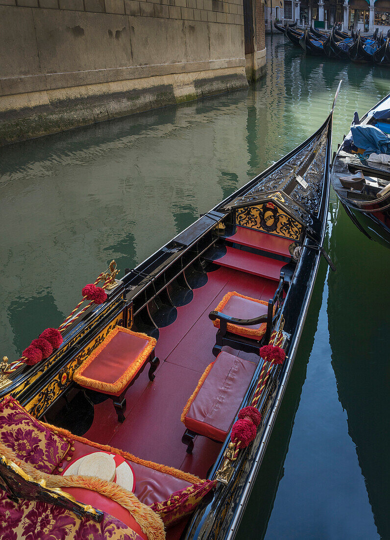 Empty gondola sailing on Venice canal, Veneto, Italy