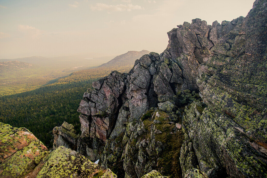 Rocky hillside over remote landscape