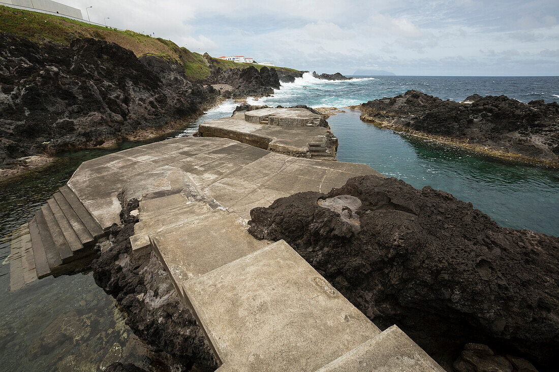 Concrete path to public swimming pool near ocean