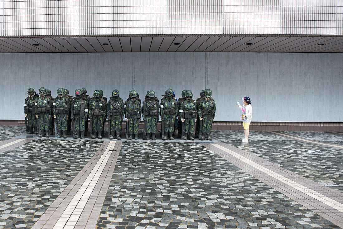 Woman photographs art installation outside Hong Kong Museum of Art, Hong Kong, Hong Kong, Asia