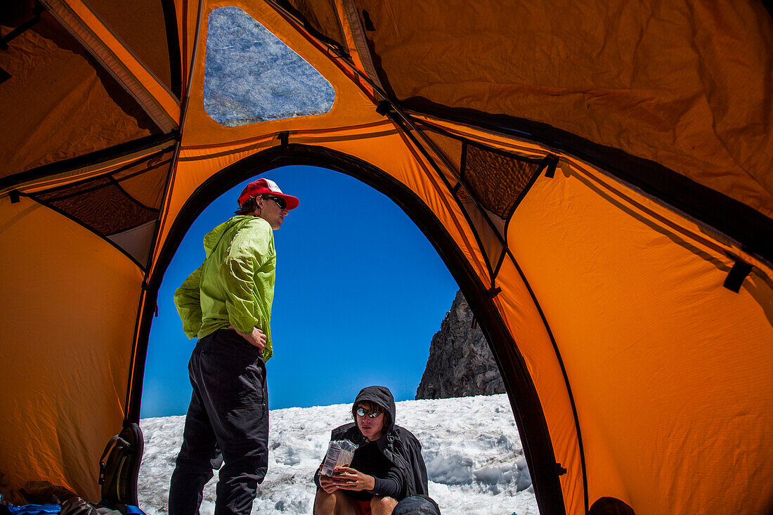 Climbers rest in their tents while ascending Mount Rainier in Mount Rainier National Park, Washington, USA.