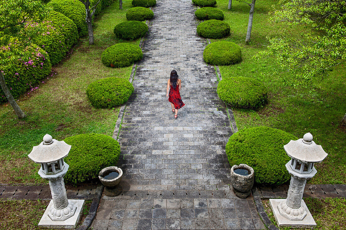 woman in red dress at a temple on Jeju Island