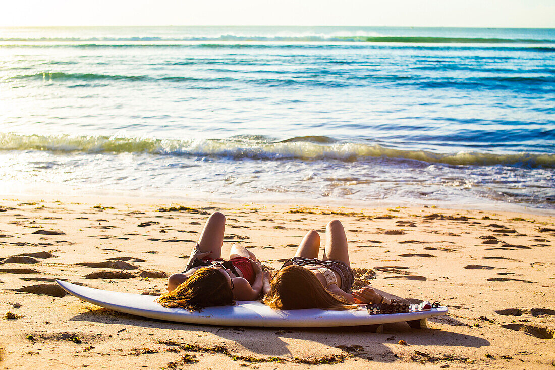 Surfer girls at the beach.