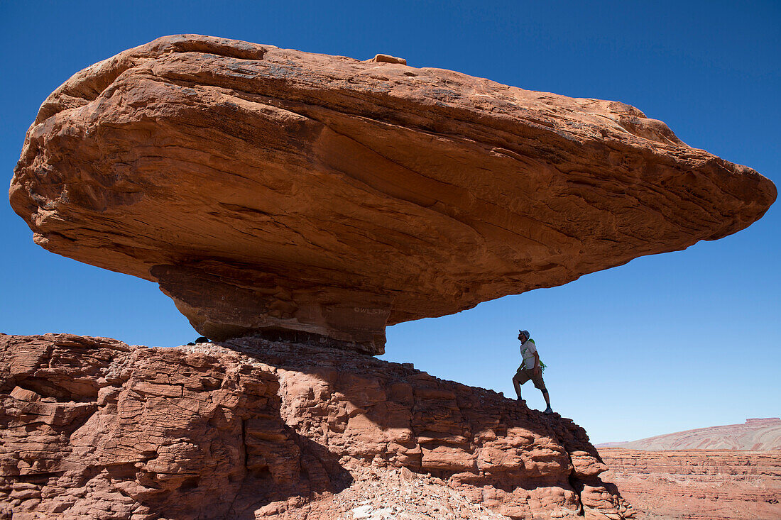 Eric Odenthal standing beneath the Mexican Hat rock formation, Utah.