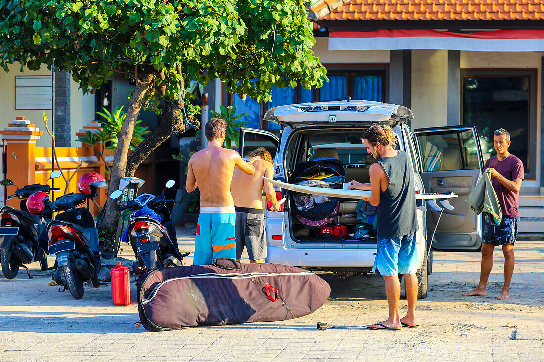 Surfers  Getting Ready to Ride the Surf.