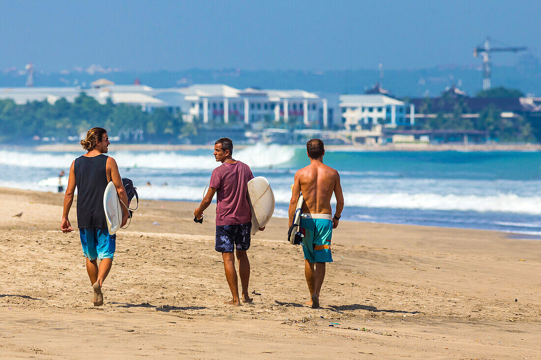 Surfers on a beach, Bali, Indonesia.