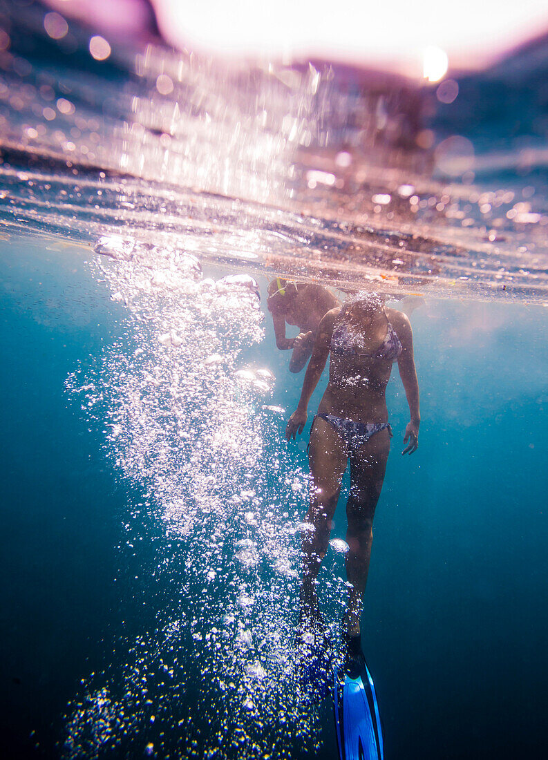 Young woman snorkeling in ocean.