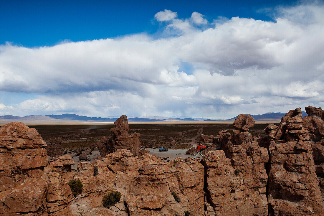 A young man plays on the rocks in the Atacama Desert. The Salar de Uyuni is the world's largest salt flat and home to one of the largest deposits of lithium in the world. The communities surrounding this region could potentially benefit greatly or suffer 