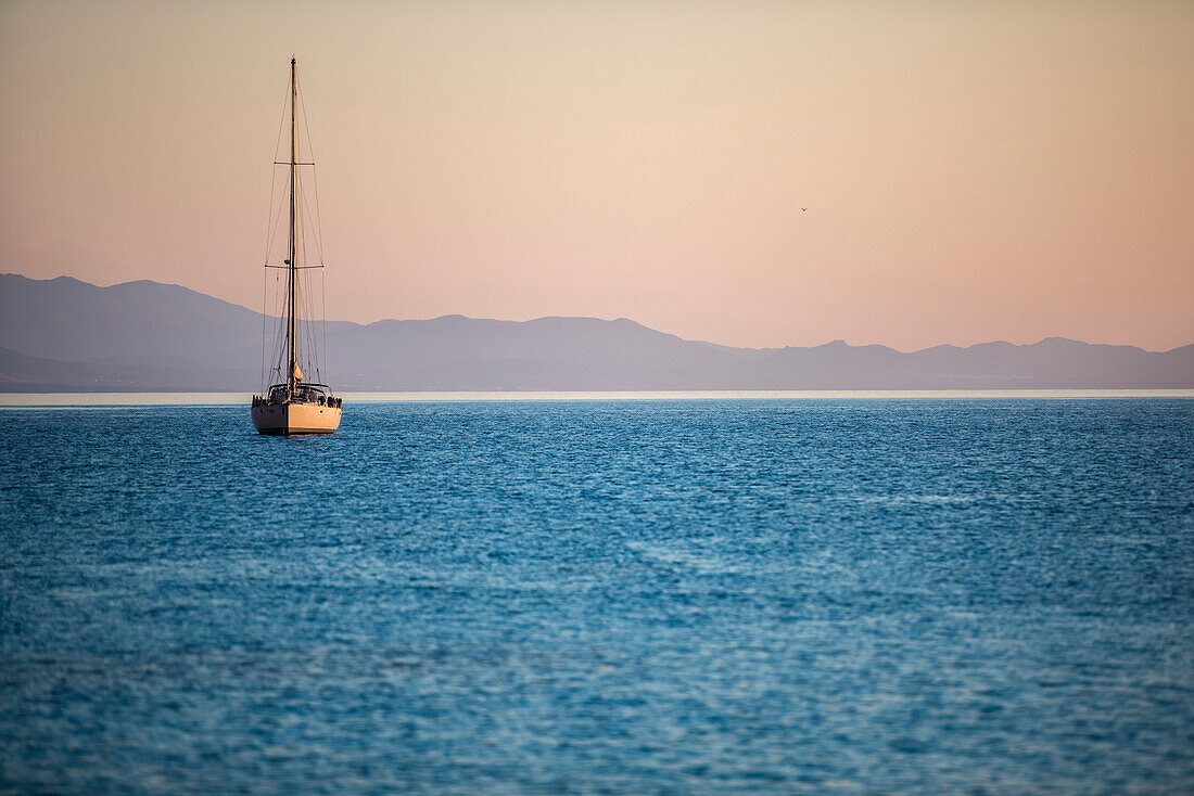 Sailboats at sunrise in Cala Goloritzè, Sardinia, Italy.