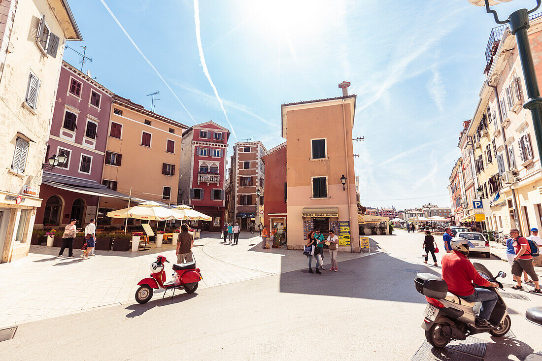 Pedestrians and scooters in the historic center of Rovinj, Istria, Croatia