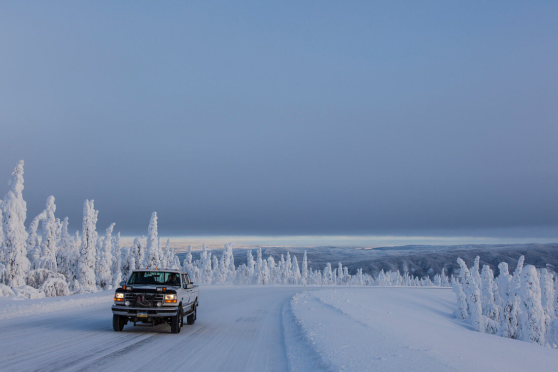 Pickup Truck on the Dalton Highway in snow covered landscape, Yukon-Koyukuk Census Area, Alaska, USA