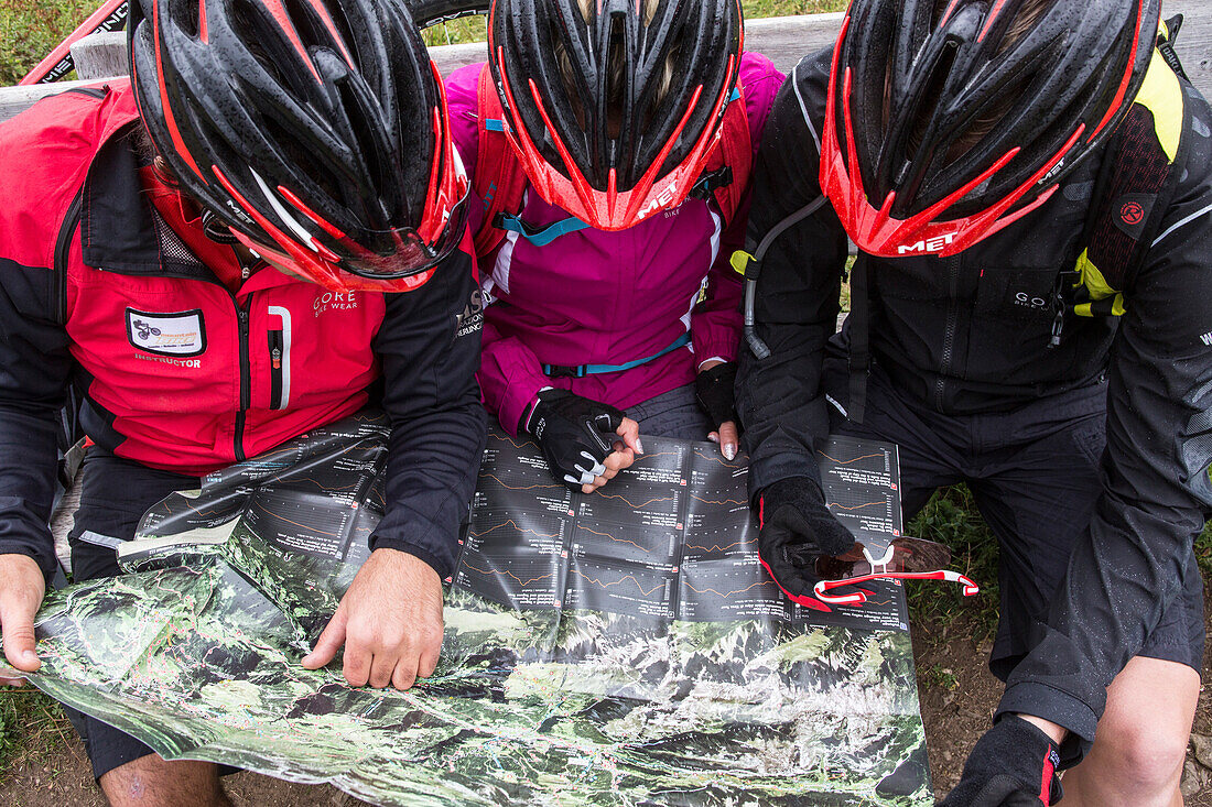 Mountain bikers with cycle helmet looking at a map, Mountain biking, MTB, Sport
