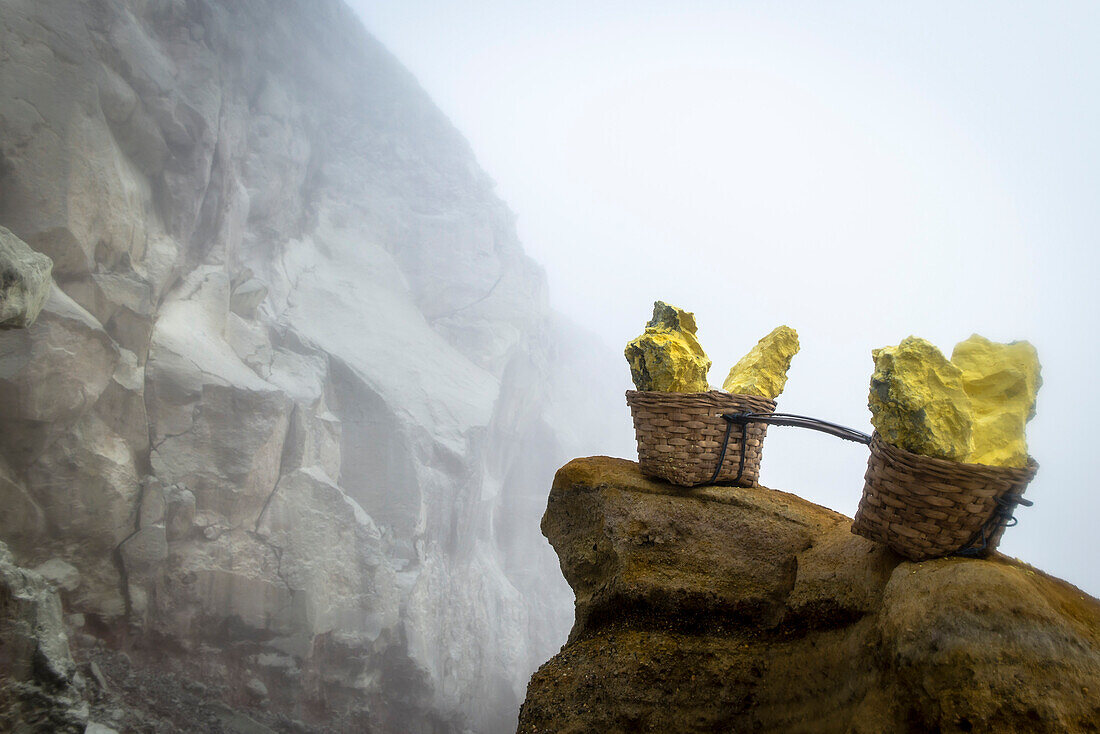 Transport baskets filled with sulfur blocks in the crater of volcano Ijen - Indonesia, Java