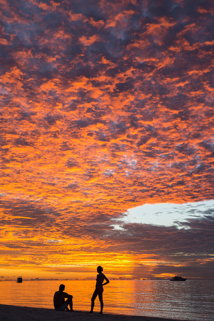 Sunset with two people at Meeru Island Resort, Meerufenfushi, North-Male-Atoll, Maldives