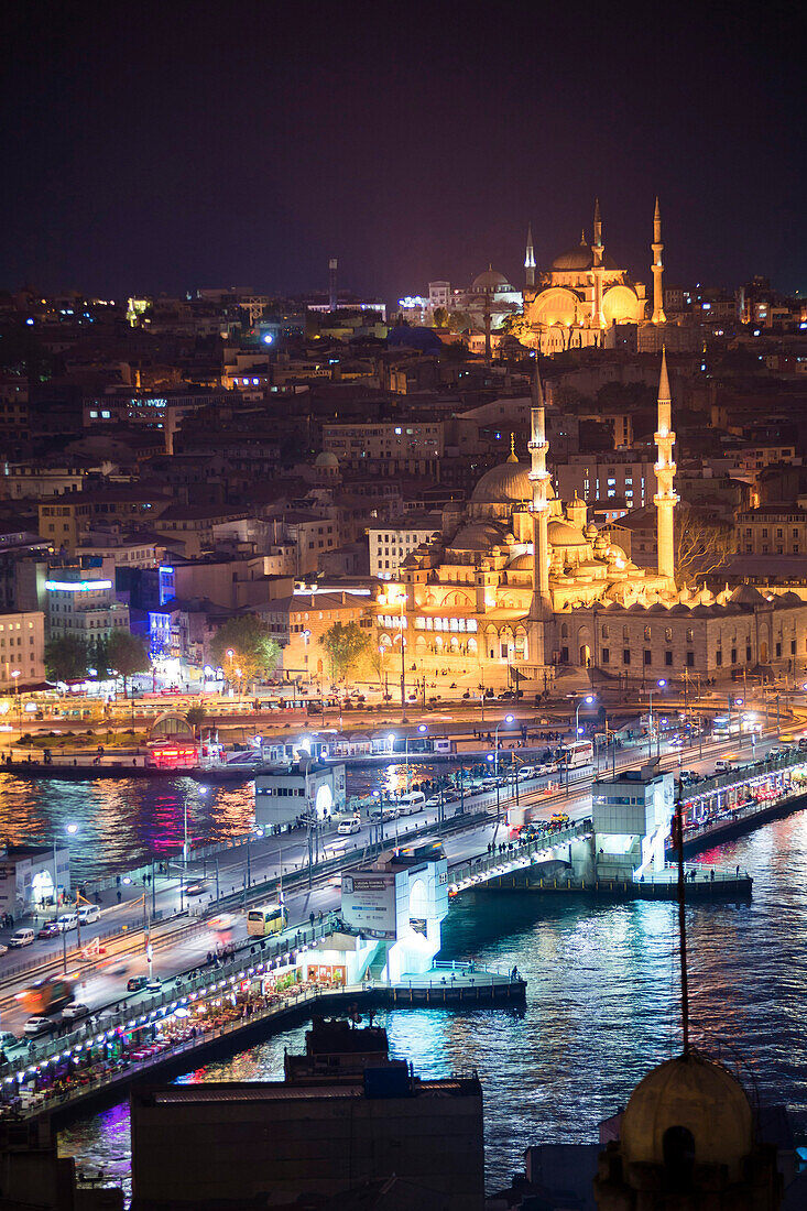 New Mosque Yeni Cami and Galata Bridge across Golden Horn at night seen from Galata Tower, Istanbul, Turkey, Europe