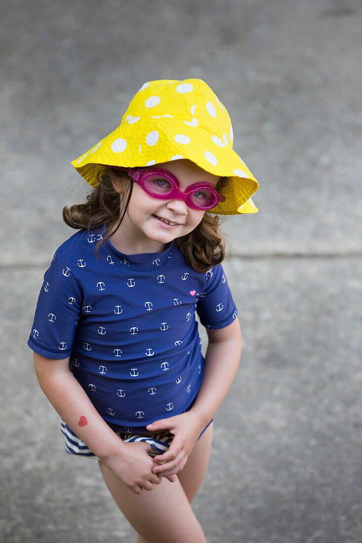 Caucasian girl wearing goggles and sun hat