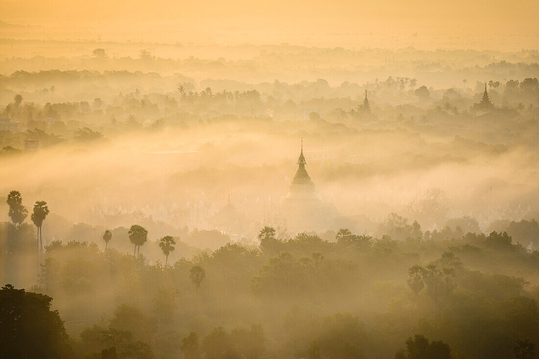 Aerial view of towers in misty landscape