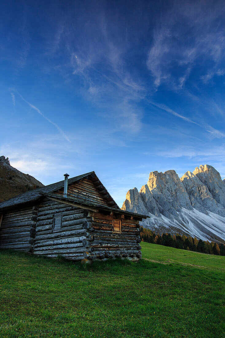 The early morning light illuminates Malga Zannes and the Odle in background, Funes Valley, South Tyrol, Dolomites, Italy, Europe