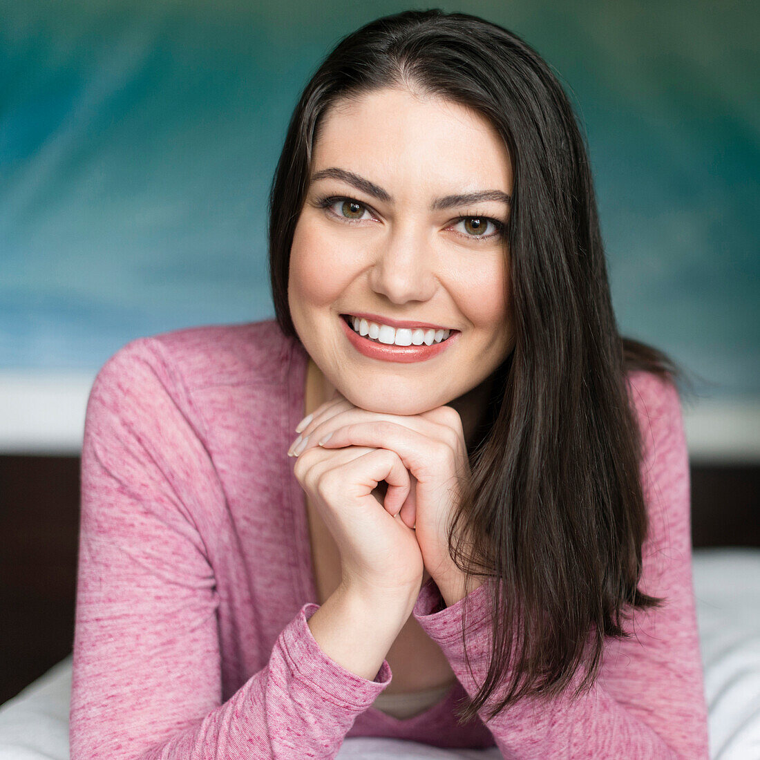 Hispanic woman resting chin in hands