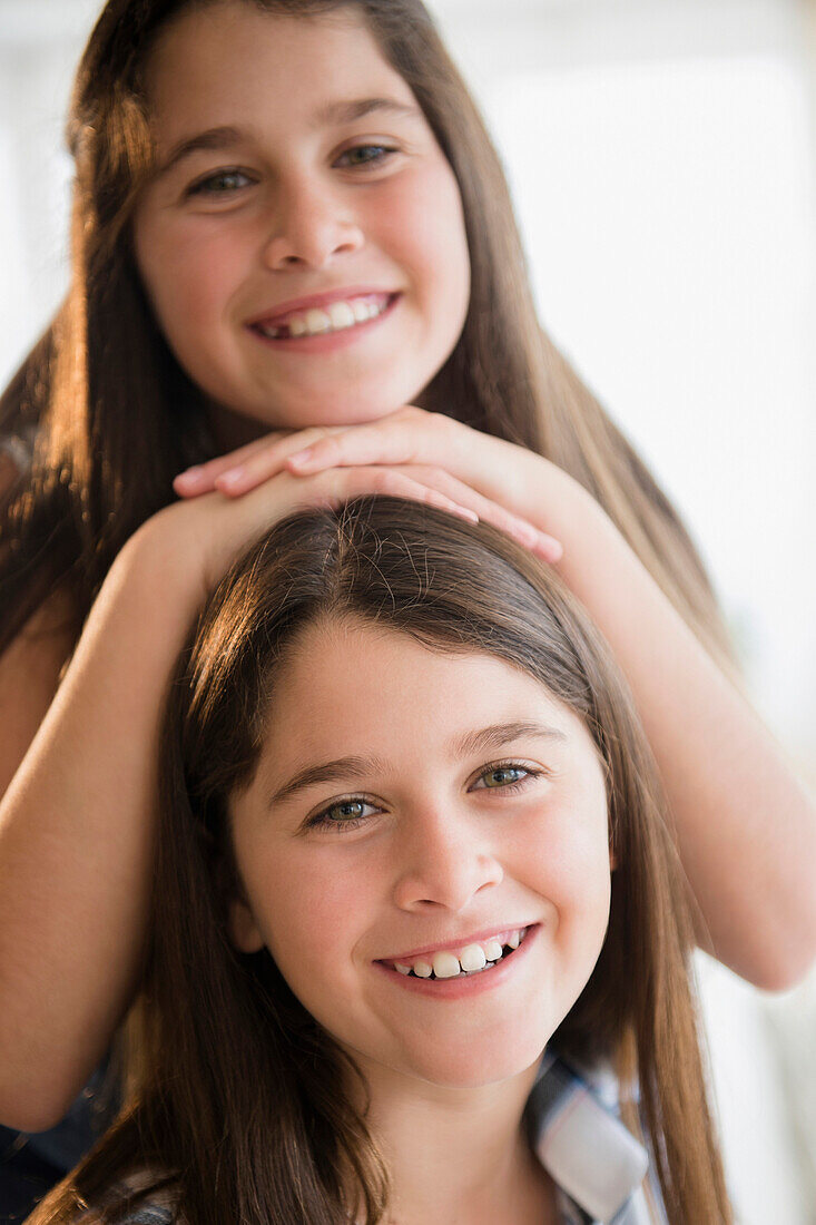 Caucasian twin sisters smiling