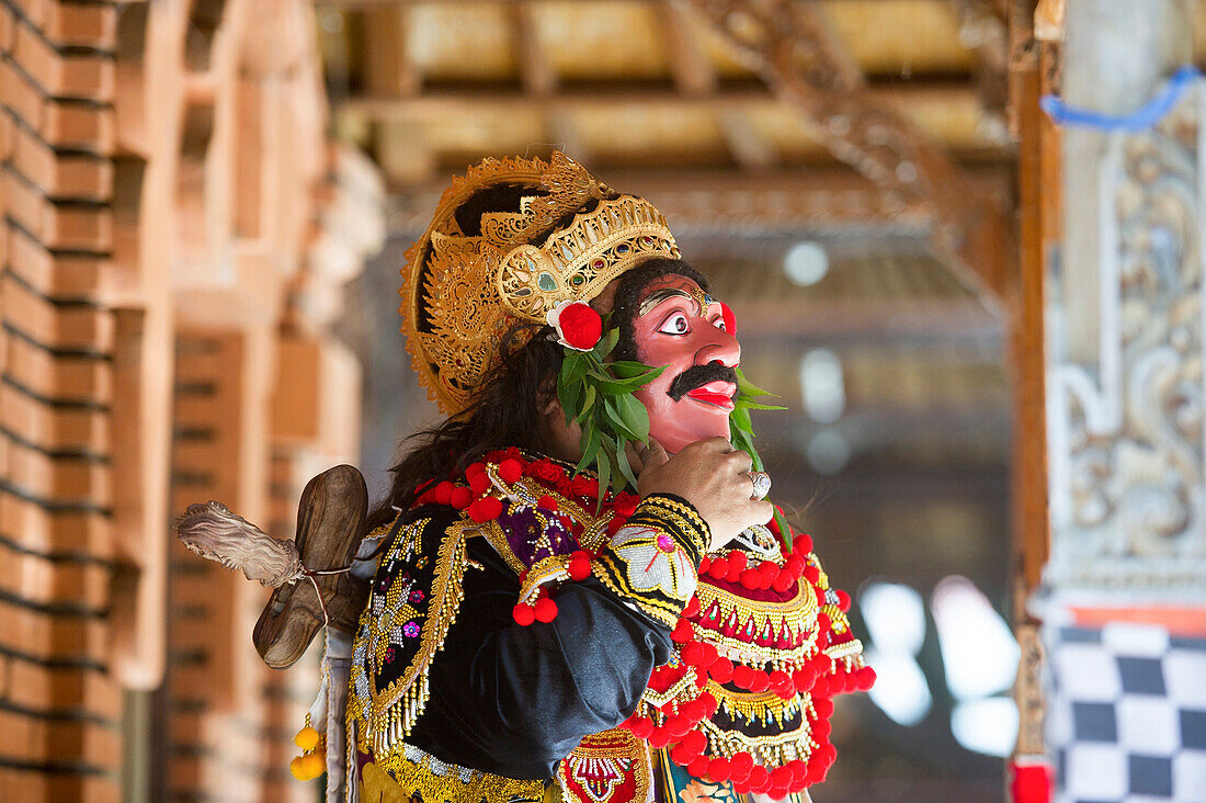 Traditional dancer standing in Buddhist temple, Kintamani, Bali, Indonesia