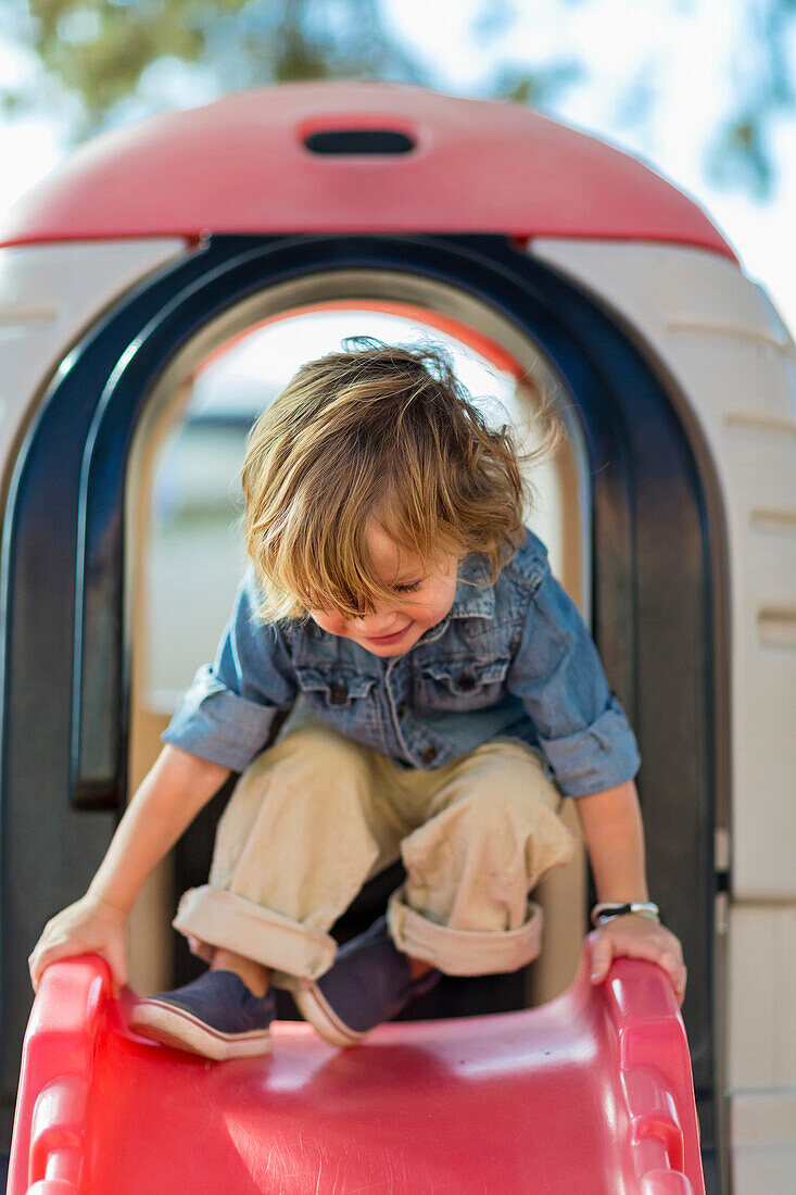 Caucasian boy playing at playground